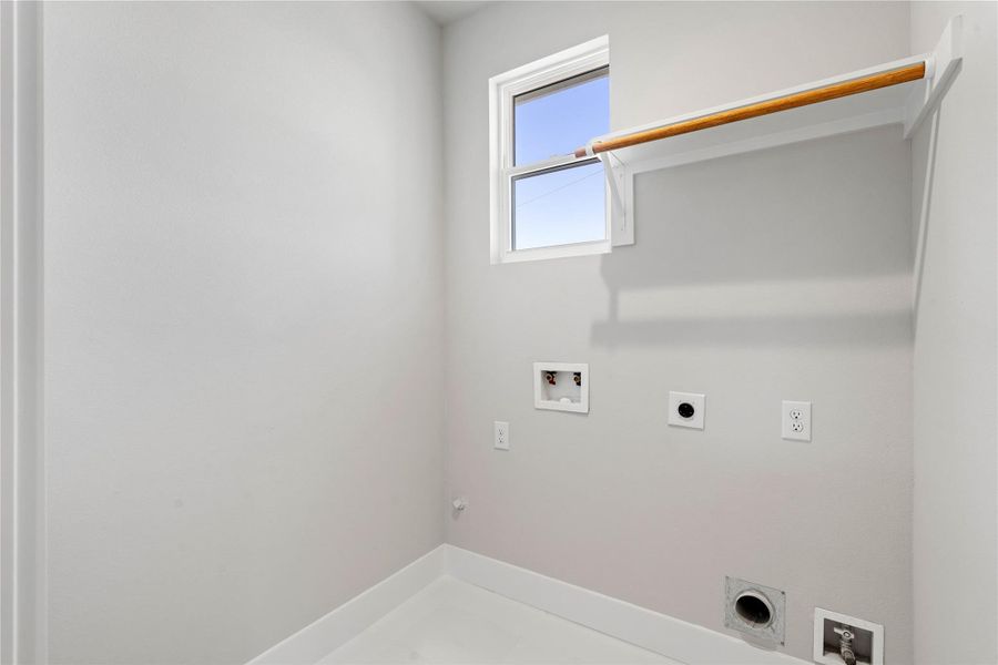 Dedicated laundry room with utility connections and built in shelving for hanging the delicate garments. Dedicated laundry room with utility connections and built in shelving for hanging the delicate garments.