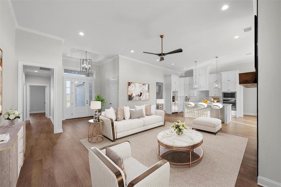 Living area with ceiling fan, recessed lighting, light wood-style floors, ornamental molding, and a chandelier Living area with ceiling fan, recessed lighting, light wood-style floors, ornamental molding, and a chandelier