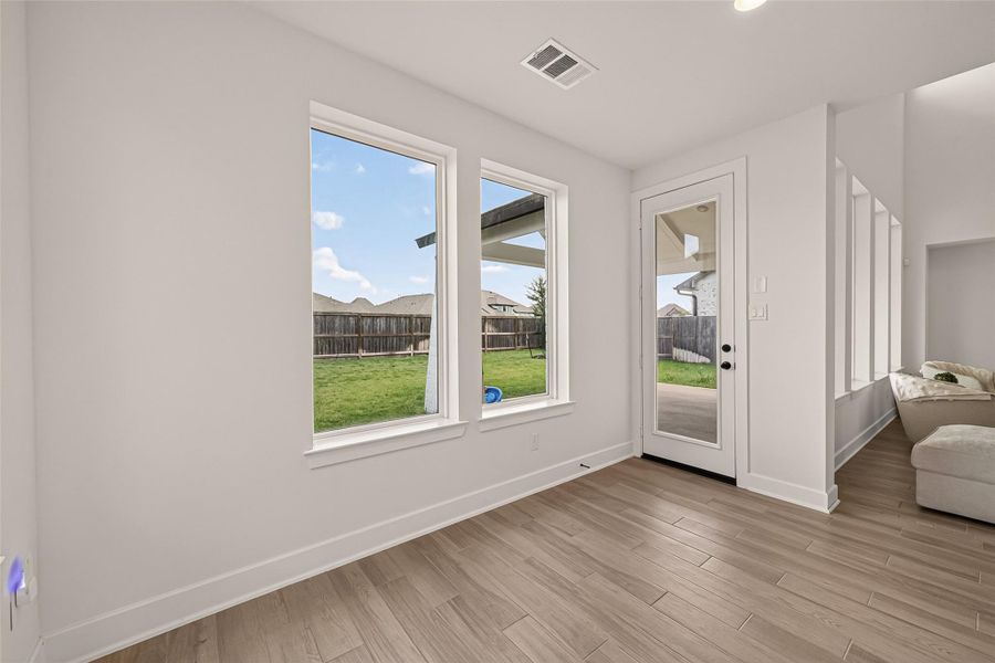 Large windows fill the breakfast area with natural light while creating the perfect space to gather with family. Large windows fill the breakfast area with natural light while creating the perfect space to gather with family.