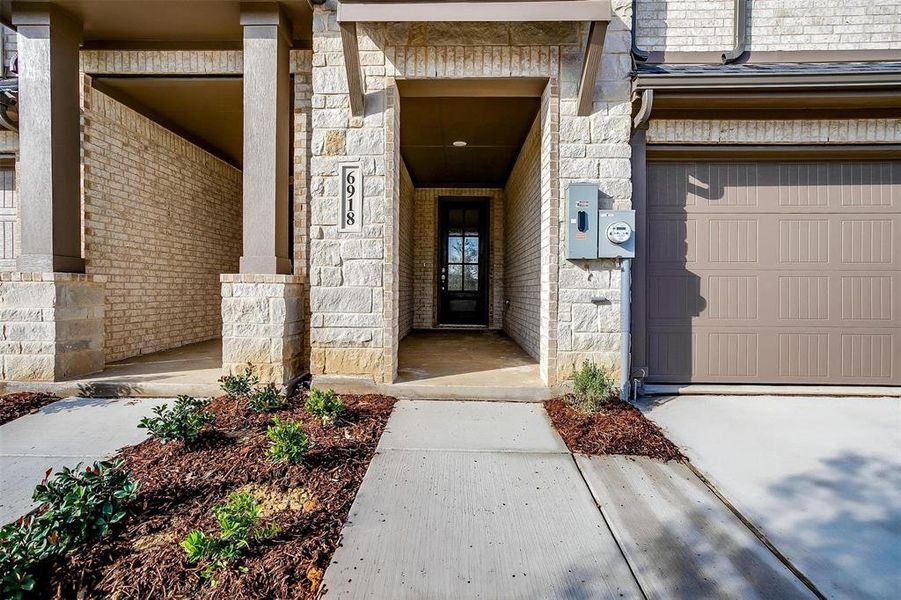 Doorway to property featuring a garage