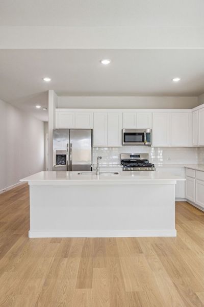 Kitchen in the Stanley II home plan by Trophy Signature Homes – REPRESENTATIVE PHOTO