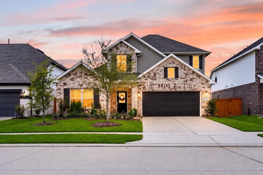 Front exterior of a new home in Marvida, Cypress, TX, highlighting curb appeal (Image 25). Front exterior of a new home in Marvida, Cypress, TX, highlighting curb appeal (Image 25).