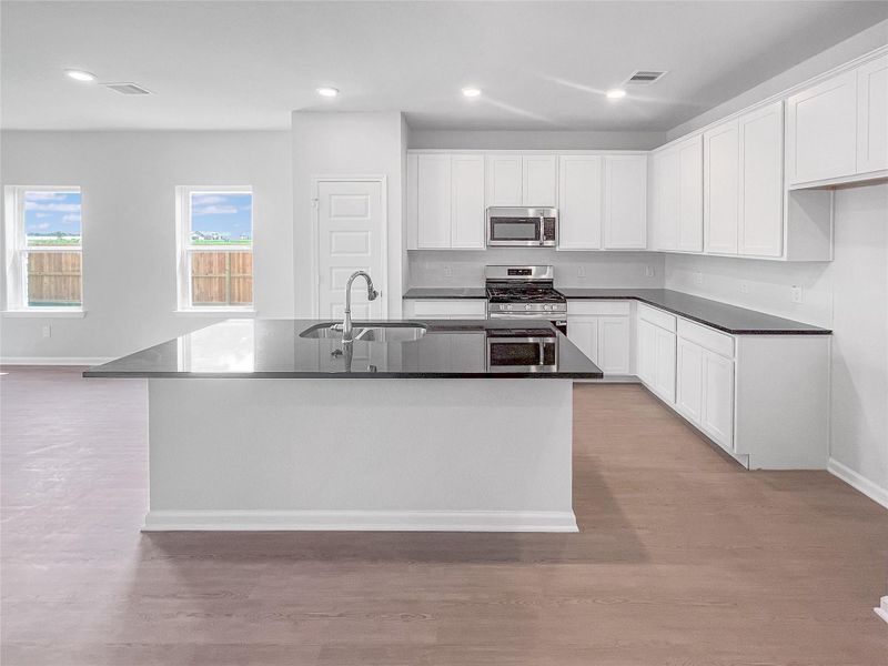 The Waring III- Kitchen with Large Island. Sample image for illustration; upgrades, options, and colors may vary.