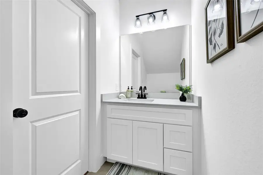 Convenient half bath on the main floor with modern fixtures.
