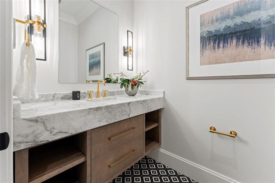 Powder bath has stunning natural quartzite stone countertops and marble floors.