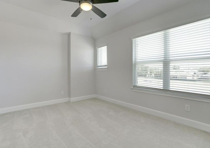 Secondary bedroom with large windows.