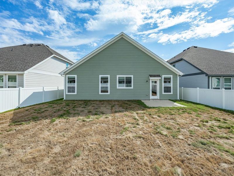 Rear view of house with a patio and a fenced backyard Rear view of house with a patio and a fenced backyard