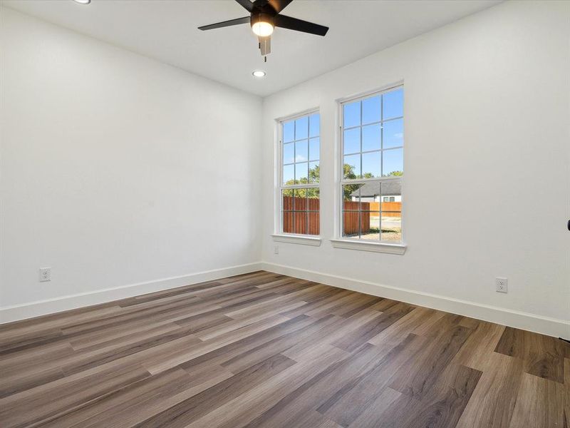 Empty room with hardwood / wood-style flooring and ceiling fan