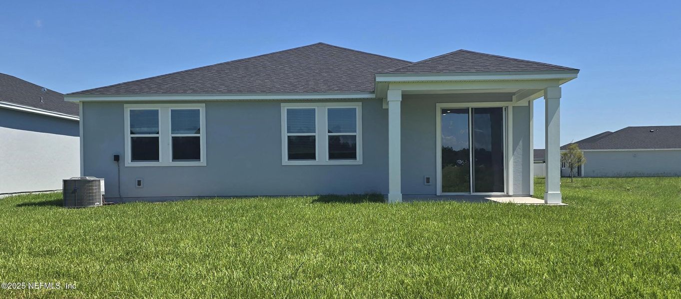 Front exterior of a new home in Lakes at Bella Lago - Signature Series, Green Cove Springs, FL, highlighting curb appeal (Image 18).