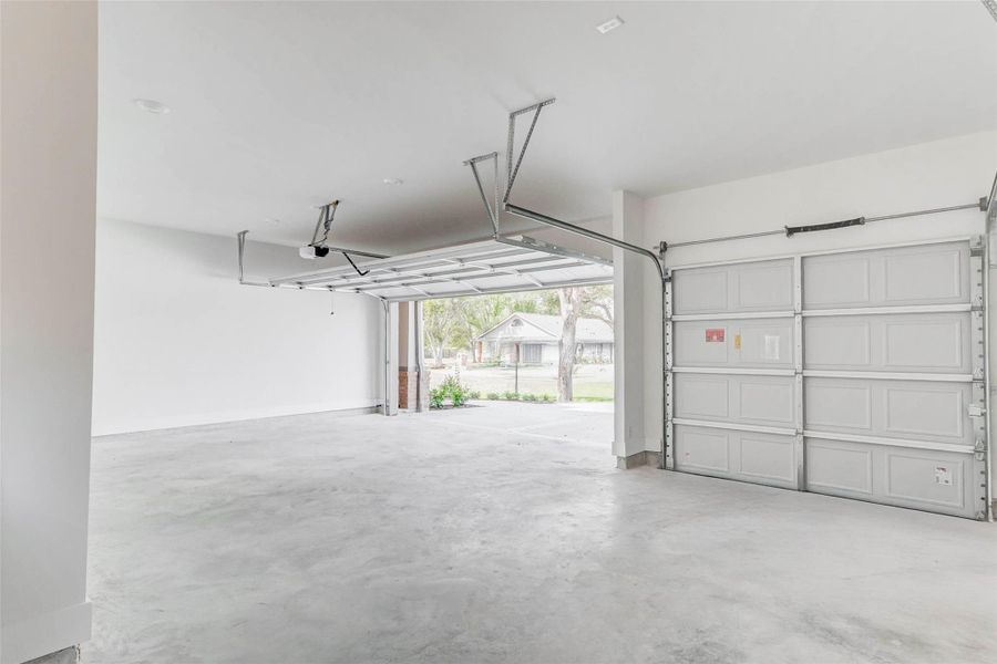 Oversized garage fits 3 vehicles easily and still has plenty of space for tools or hobbies.