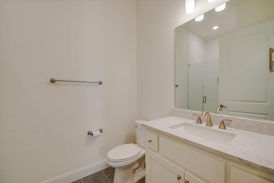 Full bathroom with tile patterned floors, vanity, and a shower stall Full bathroom with tile patterned floors, vanity, and a shower stall