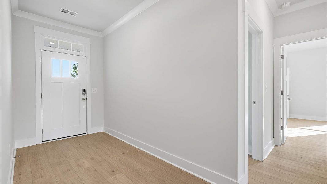 Superior design begins at the front door with a hardwood floor foyer and elegant sightlines at Wells Crossing