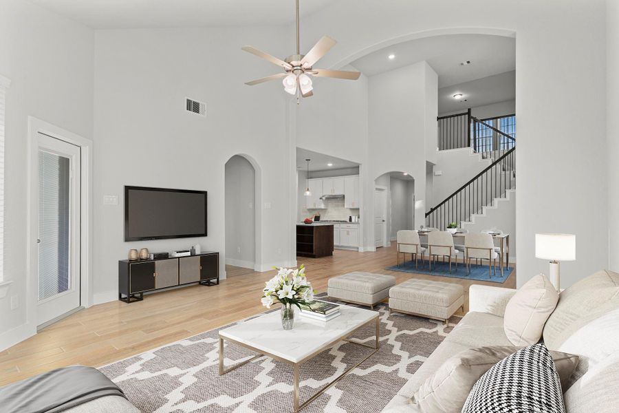 The open-concept design connects the family area to the kitchen and dining spaces for effortless flow, allowing natural light to fill every corner of the home with warmth and comfort. *Staged Photo* The open-concept design connects the family area to the kitchen and dining spaces for effortless flow, allowing natural light to fill every corner of the home with warmth and comfort. *Staged Photo*