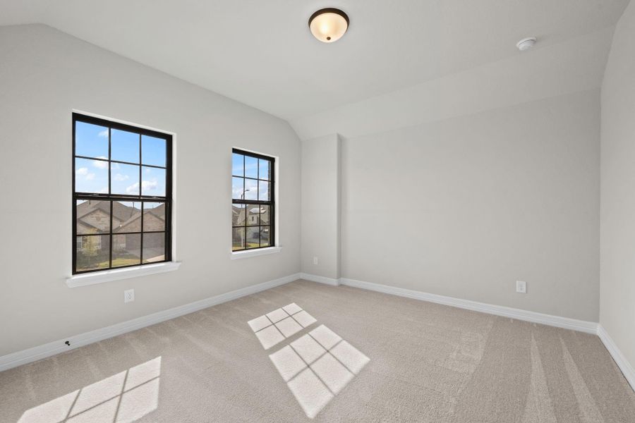 Your secondary bedroom features plush carpet, fresh paint, closet, and a large window that lets in plenty of natural lighting.