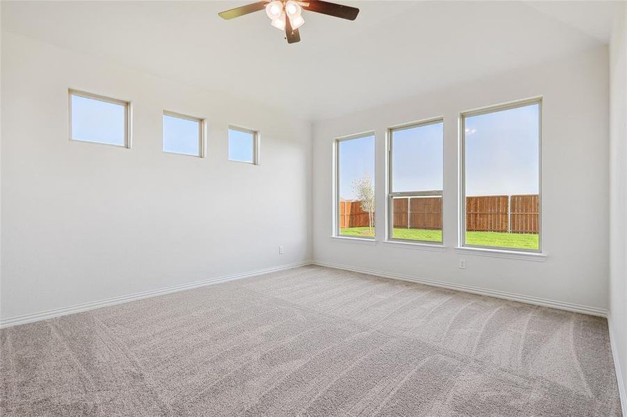 Unfurnished room with ceiling fan and carpet floors