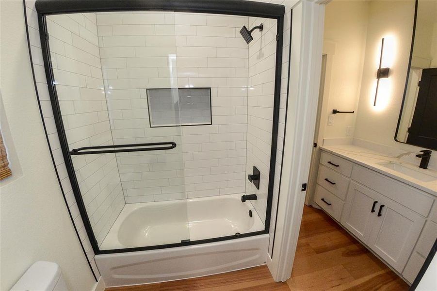 Full bath with wood finished floors, bathing tub / shower combination, and vanity