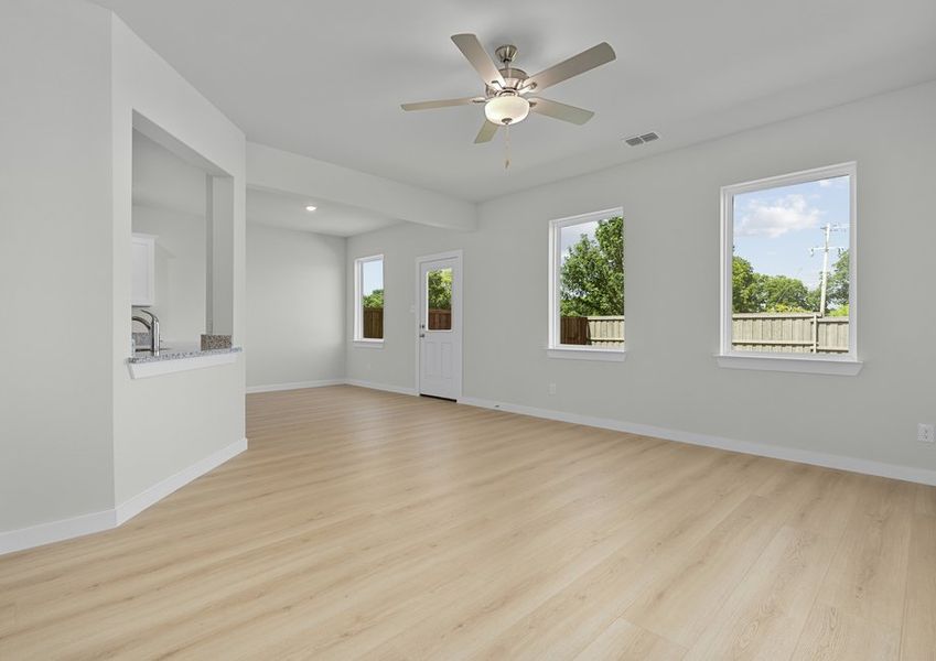 Open floor plan boasts plenty of windows and light vinyl plank flooring to keep the space bright.