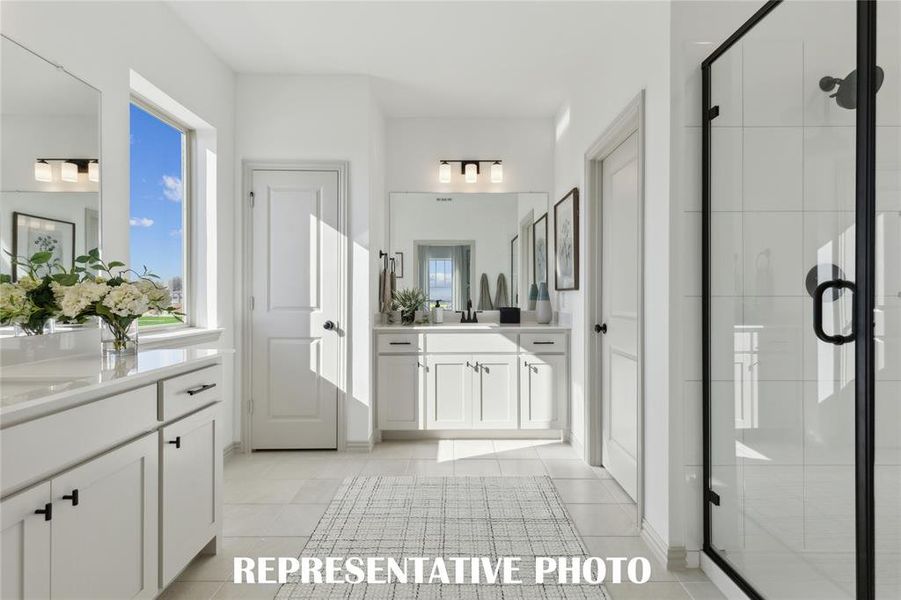 With separate vanities, you'll find plenty of space for 2 in this lovely owner's bath.  REPRESENTATIVE PHOTO