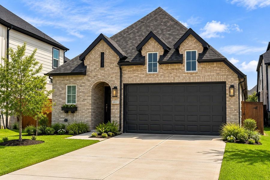 Front exterior of a new home in Meridiana, Iowa Colony, TX, highlighting curb appeal (Image 19).