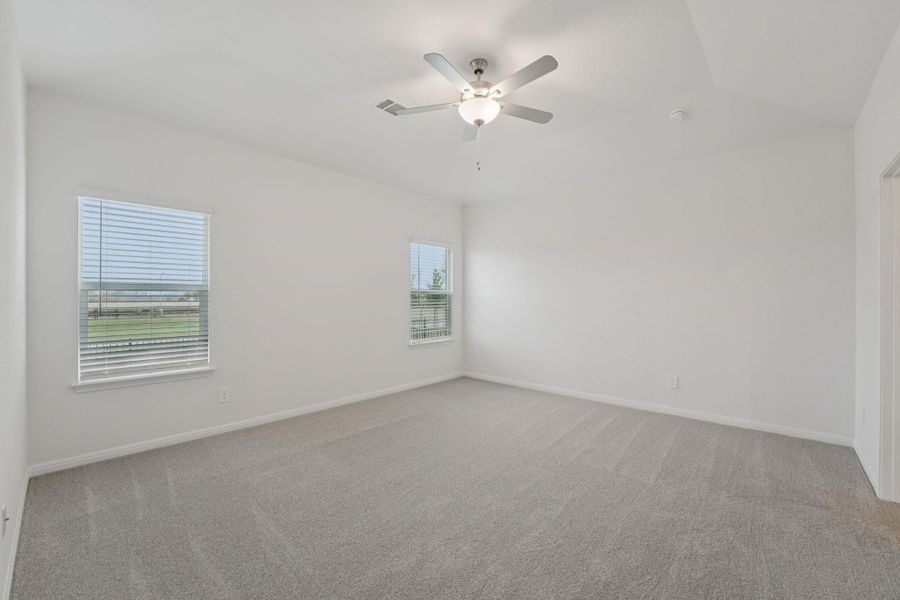 Empty room with light carpet and ceiling fan