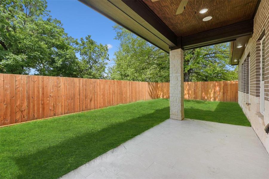 Spacious backyard with a covered patio. Fully fenced.