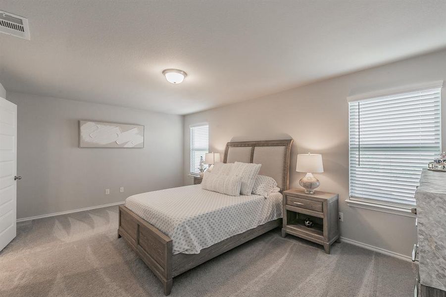 Bedroom with carpet flooring and baseboards