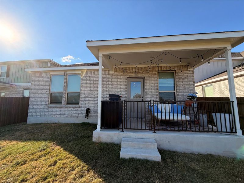 Back of property featuring brick siding Back of property featuring brick siding