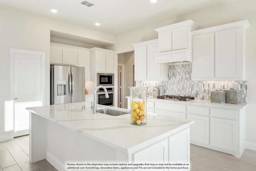 Kitchen with white cabinets, large island with sink, stainless steel appliances, and gray tile backsplash