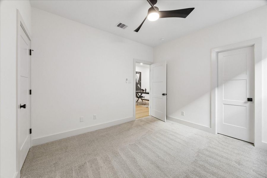 Alternate view of secondary bedroom with en-suite bathroom and walk-in closet.