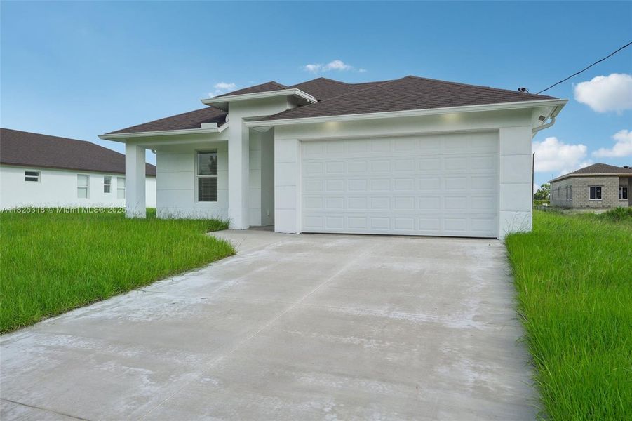 Front exterior of a new home in , Lehigh Acres, FL, highlighting curb appeal (Image 18). Front exterior of a new home in , Lehigh Acres, FL, highlighting curb appeal (Image 18).