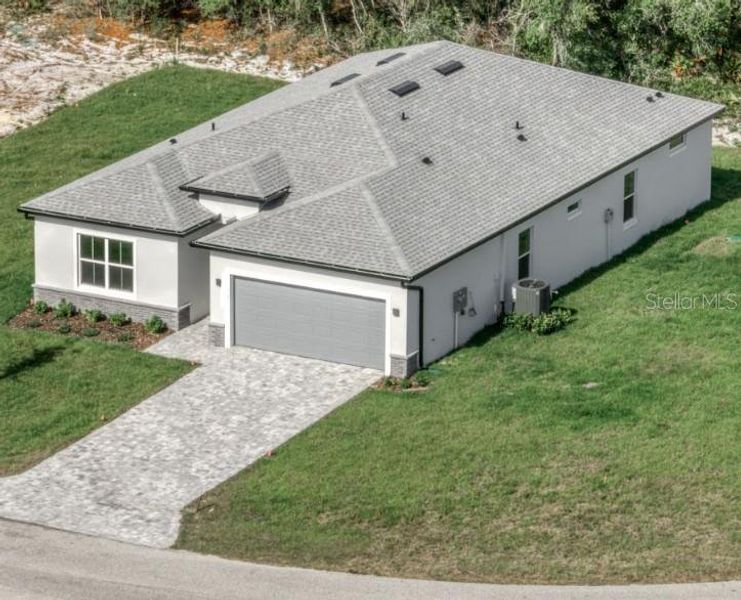 Front exterior of a new home in , Summerfield, FL, highlighting curb appeal (Image 1).