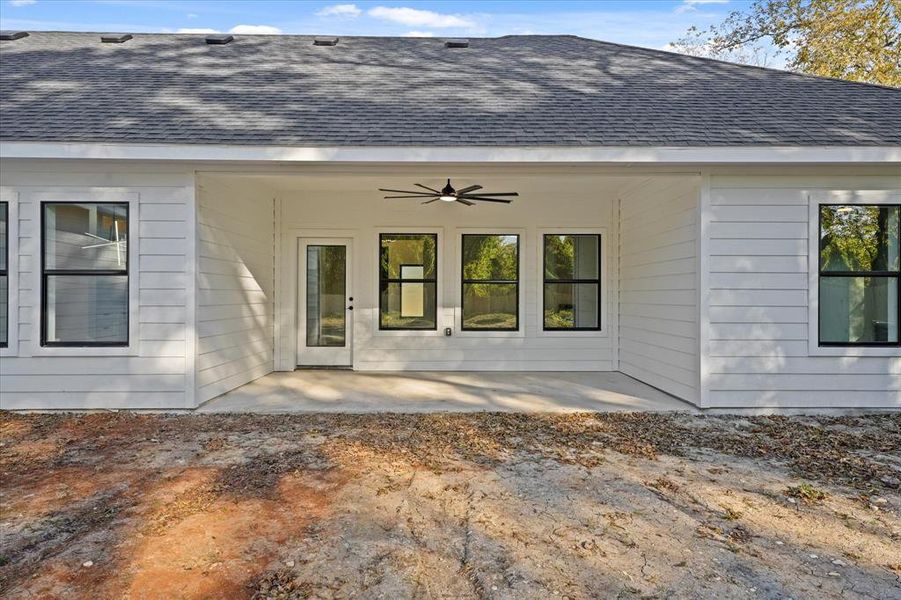 View of exterior entry featuring ceiling fan and a patio