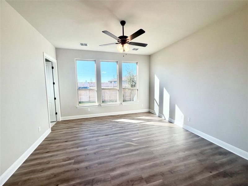 Empty room featuring dark wood-style floors and a ceiling fan Empty room featuring dark wood-style floors and a ceiling fan