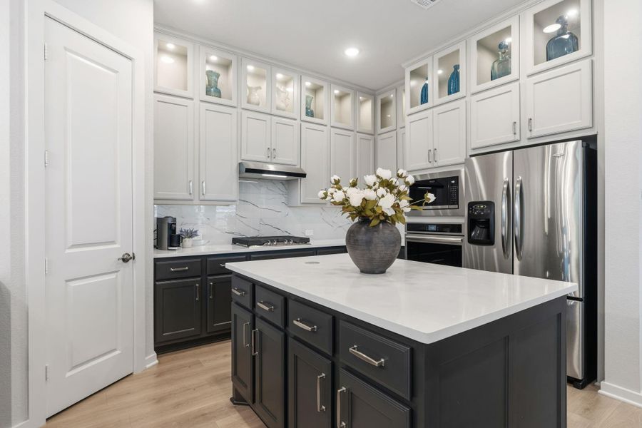 Kitchen features includes gas cooktop and separate oven and microwave - refrigerator included - all cabinets throughout the home include hardware as shown -