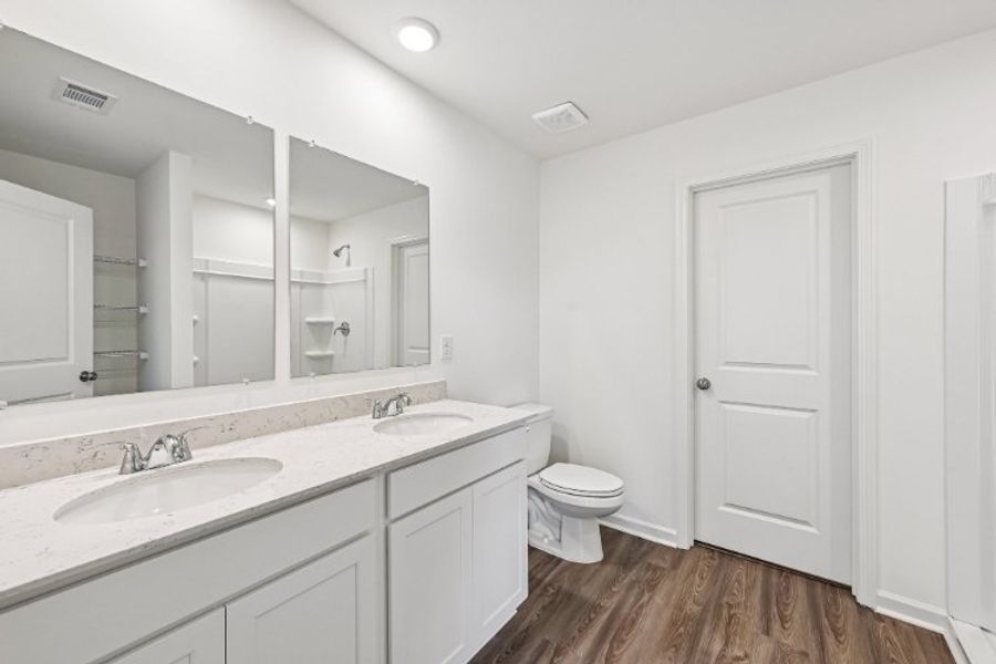 A bathroom with a large mirror. A bathroom with a large mirror.