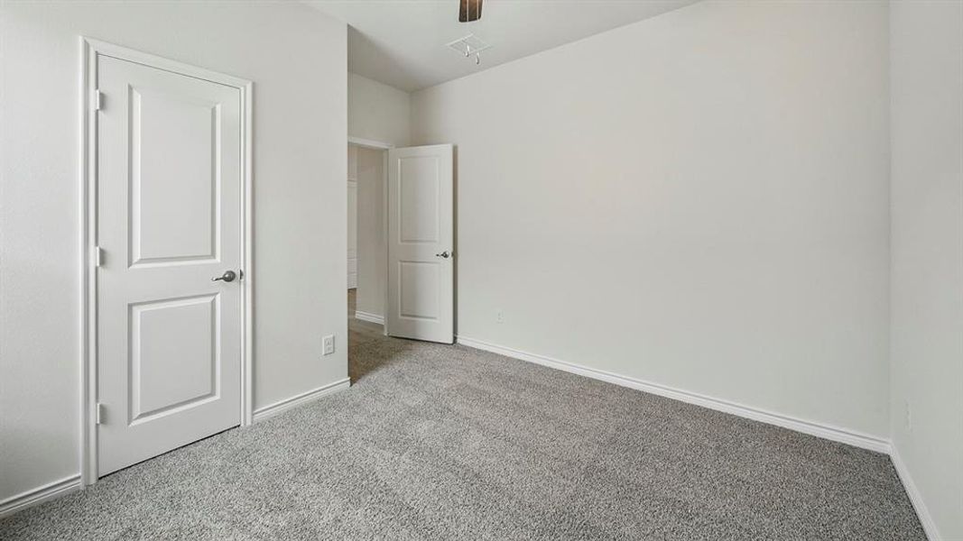 Unfurnished bedroom with carpet flooring and ceiling fan