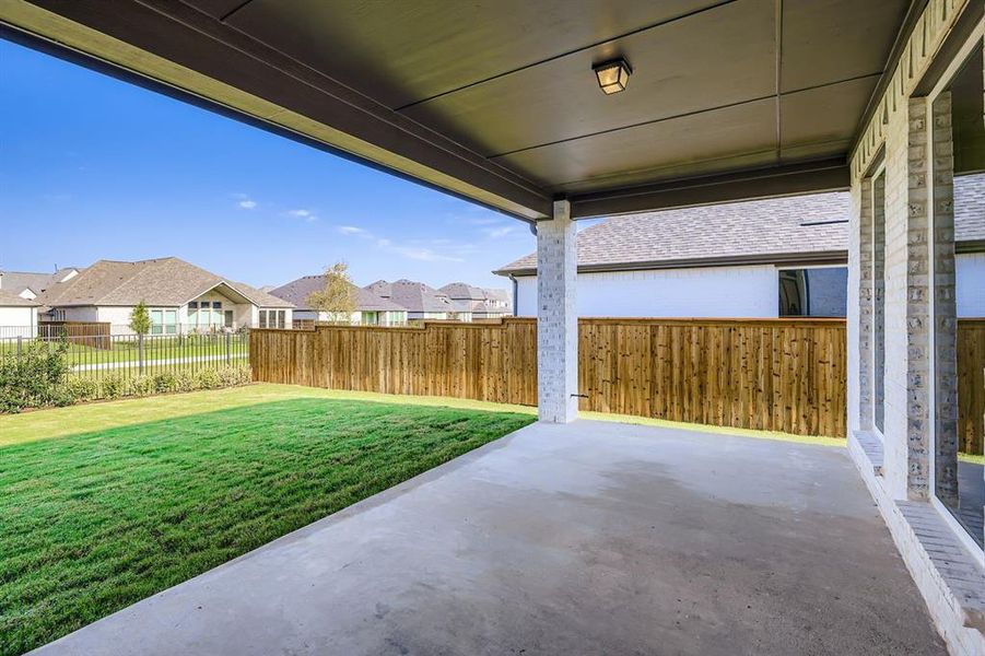 Fenced backyard featuring a residential view and a patio area