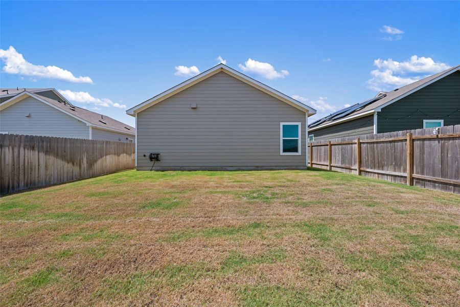 Rear view of property with a fenced backyard Rear view of property with a fenced backyard