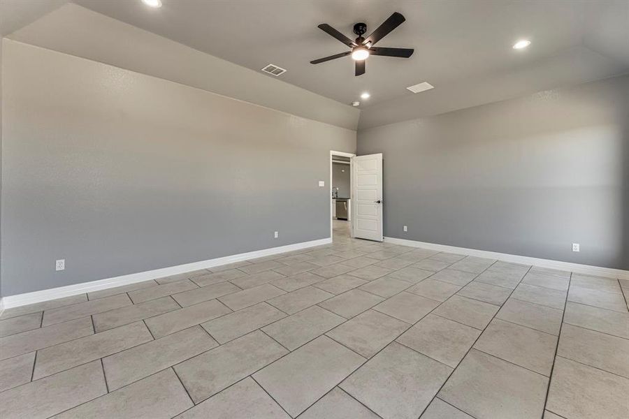 Tiled empty room featuring ceiling fan