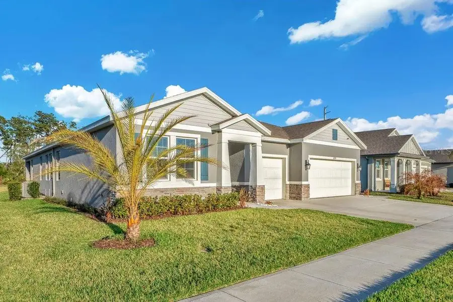Front exterior of a new home in Archers Mill, Ormond Beach, FL, highlighting curb appeal (Image 1). Front exterior of a new home in Archers Mill, Ormond Beach, FL, highlighting curb appeal (Image 1).