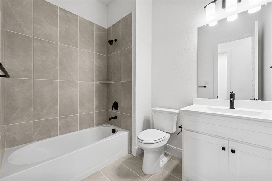 Bathroom with vanity, shower / washtub combination, and light tile patterned floors Bathroom with vanity, shower / washtub combination, and light tile patterned floors