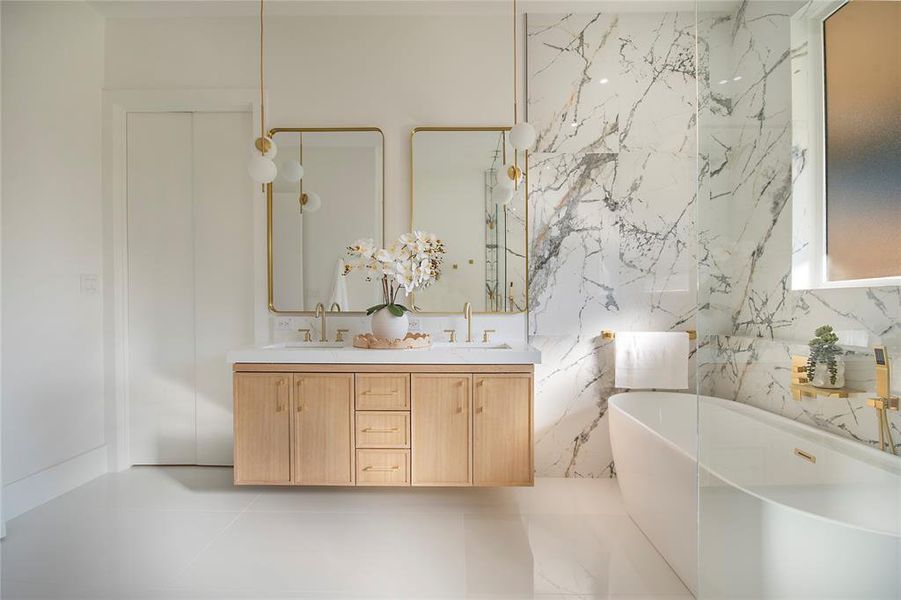 Bathroom featuring a soaking tub and double vanity Bathroom featuring a soaking tub and double vanity