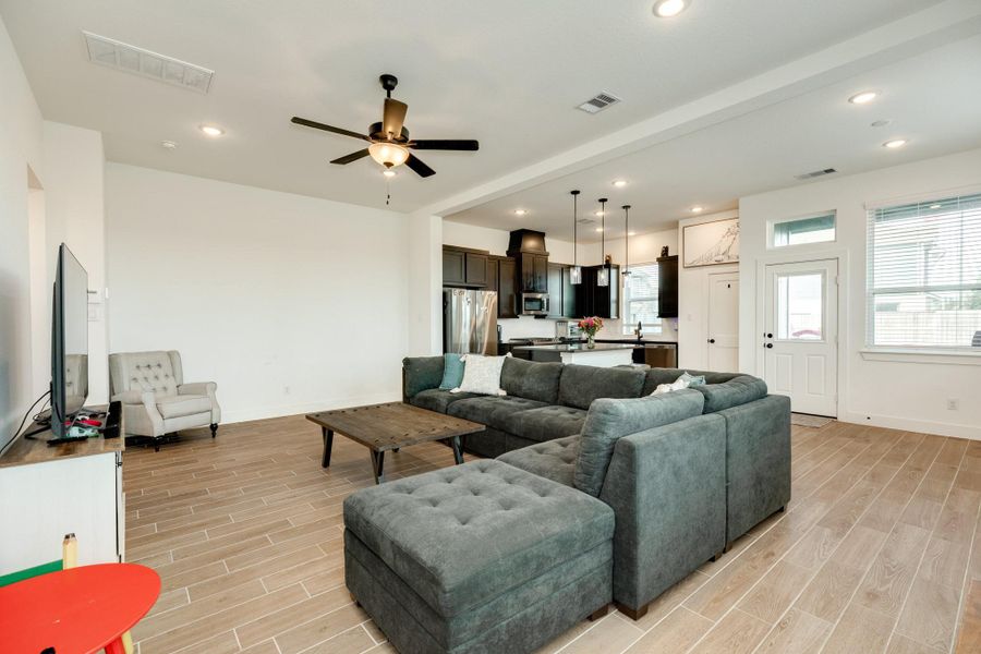 Garage entrance view with beautiful tile flooring and ample natural light from the numerous windows.