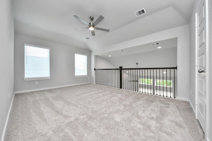 Come upstairs and enjoy a day of leisure in this fabulous game room! This is the perfect hangout spot or adult game room! Features plush carpet, high ceilings, custom paint and windows for plenty of natural light.