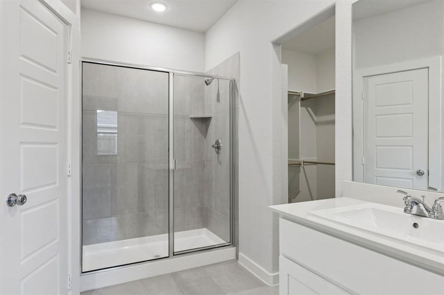 Primary Bathroom in the Cedar home plan by Trophy Signature Homes – REPRESENTATIVE PHOTO