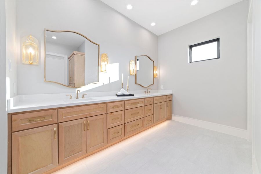 Beautiful primary bath cabinetry offering abundant storage, quartz countertops, and stylish finishes.