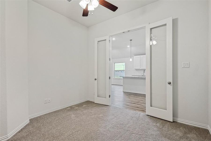 Unfurnished room featuring ceiling fan and carpet floors