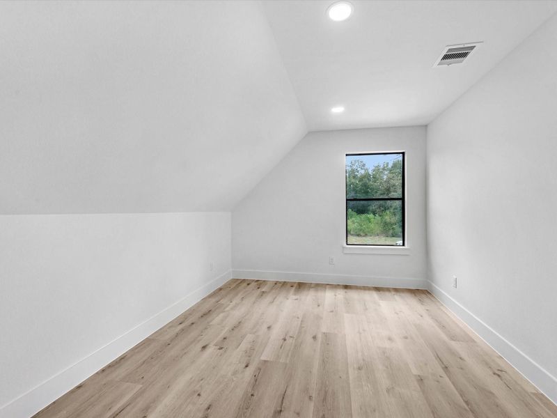 this fourth bedroom has a unique touch making it great for a gym, library, playroom and so much more!