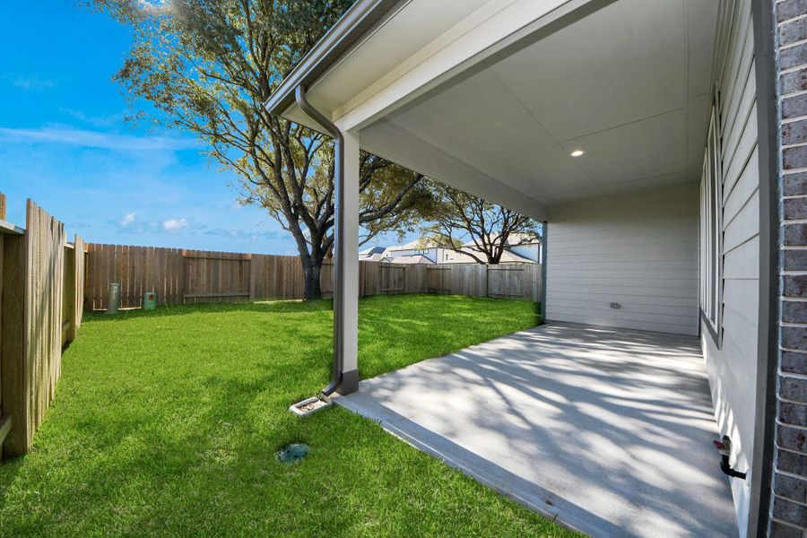 Experience outdoor living at its finest on this expansive covered patio, thoughtfully designed for BBQs and delightful outdoor dining.