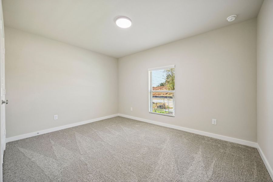 Bedroom in the Harrison home plan by Trophy Signature Homes